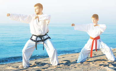 Man and boy practising karate