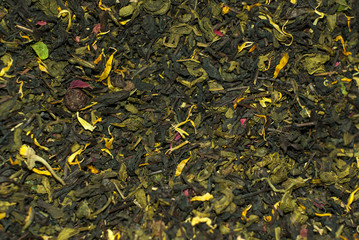 background - flavored blend of green and black tea with flower petals closeup