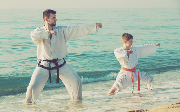 Man and boy practising karate