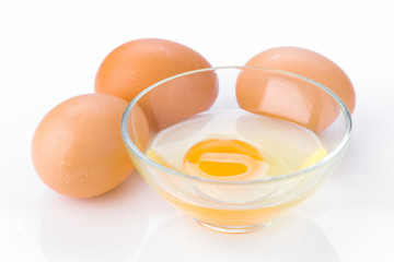 open egg in glass bowl on white background