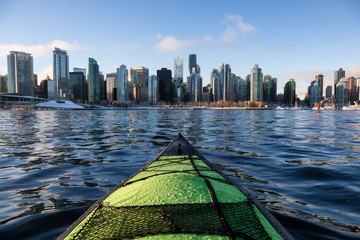 Kayaking and Paddle Boarding in Coal Harbour during a vibrant sunny morning. Taken in Downtown Vancouver, British Columbia, Canada. - obrazy, fototapety, plakaty