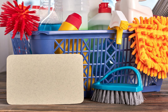 Detergents and tools for cleaning. Cleaning kit in basket. Concept of tidiness at home.