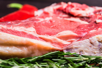 Raw beef steak with pepper and rosemary