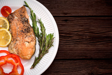 Salmon steak with vegetables top view