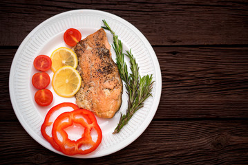 Salmon steak with vegetables top view