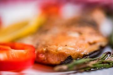 Salmon steak with vegetables close up