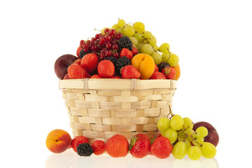 Wicker basket with mixed summer fruit