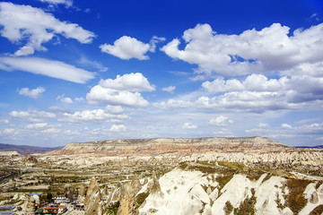 Top view on the mountain valley in clear sunny day with beautiful clouds