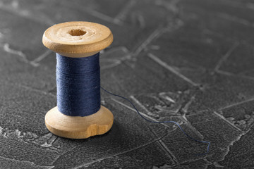Fototapeta na wymiar sewing thread on an old wooden spool
