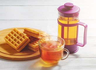 Homemade Waffles with Jam on Old Wooden Table. Wafers with Cup of Tea and Teapot.
