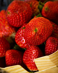 there are many red macro strawberries in Wicker basket