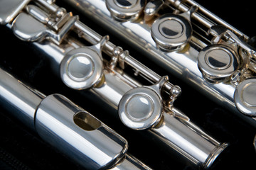 Close up of the silver plated musical instrument flute © Nikole Kelly Hill 