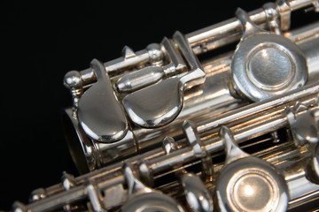 Close up of the silver plated musical instrument flute © Nikole Kelly Hill 