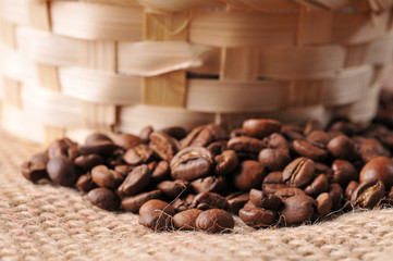 Close-up of coffee beans and basket on a burlap