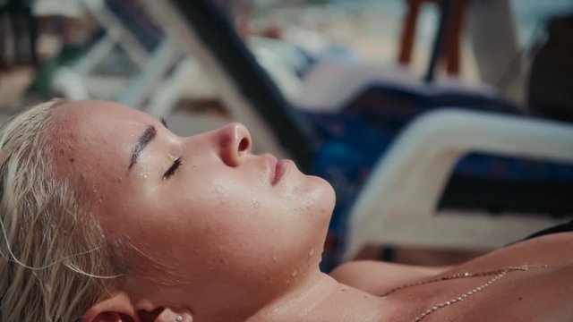 Beautiful woman in bikini sunbathing at the seaside woman blonde young sleep on beach