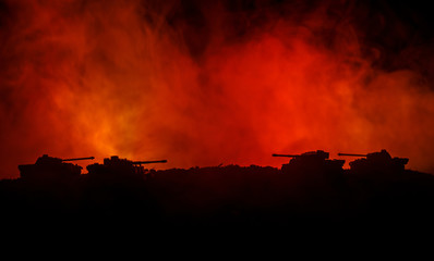 War Concept. Military silhouettes fighting scene on war fog sky background, World War German Tanks Silhouettes Below Cloudy Skyline At night. Attack scene. Armored vehicles. Tanks battle. Close up