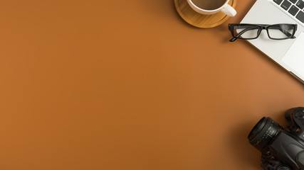 Styled stock photography brown office desk table with blank notebook, computer, supplies and coffee cup. Top view with copy space. Flat lay.