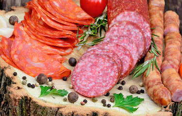 Sliced of chorizo, salami, sausages with herbs