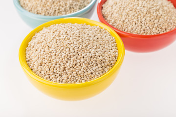 Quinoa grains in bowl isolated on white background, Chenopodium quinoa