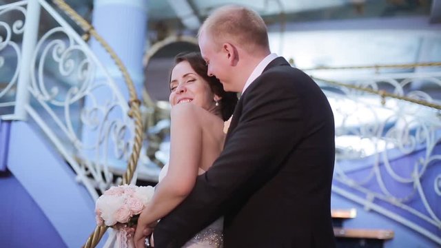 Wedding couple indoors is hugging each other