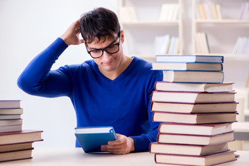 Male student preparing for exams in college library