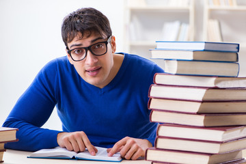 Male student preparing for exams in college library