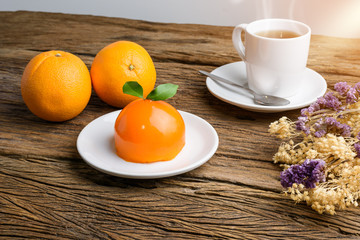Orange cake on grunge wooden table