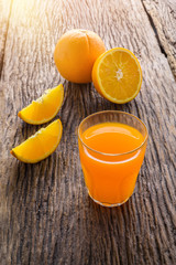 Glass of Fresh Orange Juice on grunge wooden table