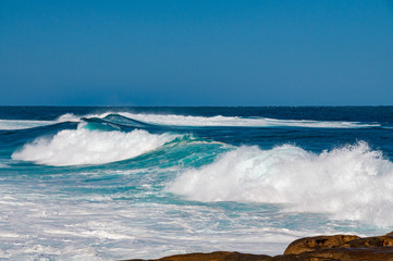 Big ocean wave with clear blue sky