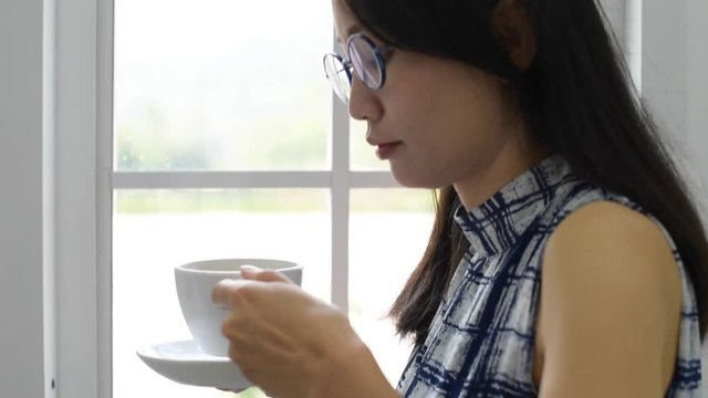 Young woman drinking coffee in the morning.