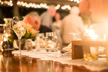Table Set Up and Decoration During a Wedding Reception Party at Night with Bokeh