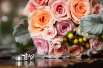 Simple Wedding Rings with a Beautiful Pink and Orange Spring Rose Wedding Bouquet