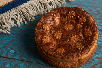 Traditional slavic russian and ukranian festivals and weddings bread Round Loaf Karavai pastry on wooden rustic table 