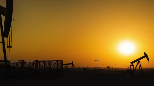 Oil Pumps Timelapse at Sunset. Zoom In and Pan