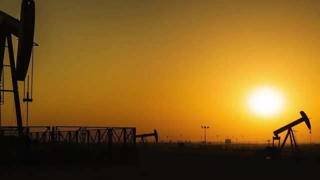 Oil Pumps Timelapse at Sunset. Zoom In