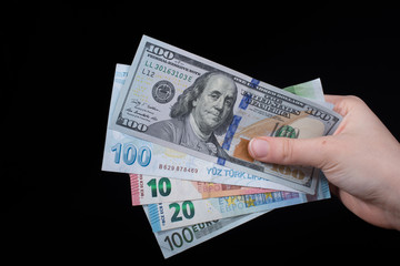 Hand holding American dollar  isolated on black background