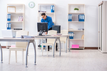 Handsome businessman employee sitting at his desk in office