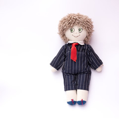Standing male rag doll with striped dress and tie on clear background with space left