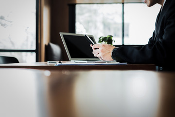 young businessman working with mobile and documentsin office, business concept