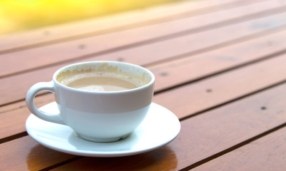 white cups with hot espresso on wood table and nature light