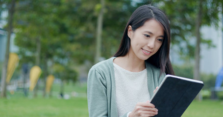 Fototapeta premium Woman working on tablet at outdoor