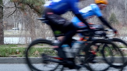Road cycling race from side perspective in slow motion