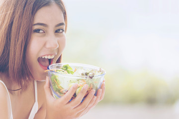 Healthy food fresh vegetable salad. beautiful woman eating healthy ingredient for good health. healthcare concepts