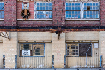 exterior of old abandoned brick warehouse in inner city
