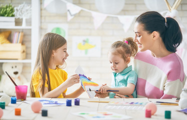 Mother and daughters painting together
