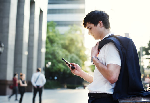 Young adult man checking his smartphone