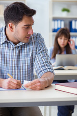 Students sitting and studying in classroom college
