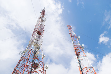 Two telecommunication tower on a sunny day against a blue sky