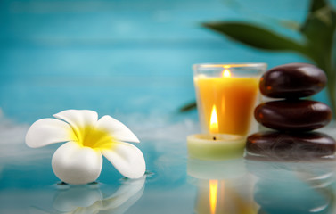 Fototapeta na wymiar spa concept with candle, stone, flower and bamboo, relaxation