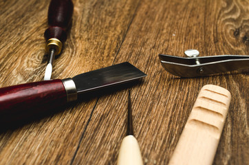 Naklejka premium Leather craft tools on wooden background